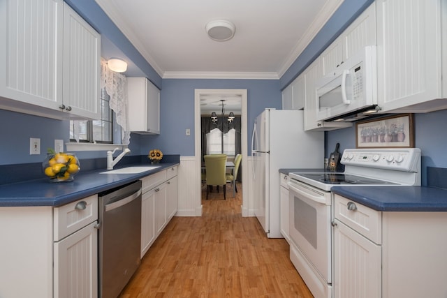 kitchen featuring white appliances, white cabinets, sink, ornamental molding, and light hardwood / wood-style flooring