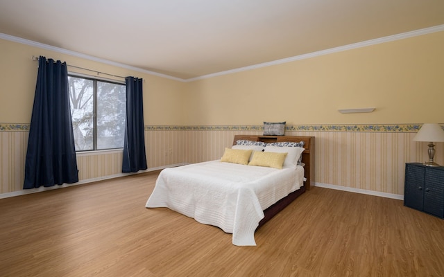 bedroom featuring ornamental molding and hardwood / wood-style floors