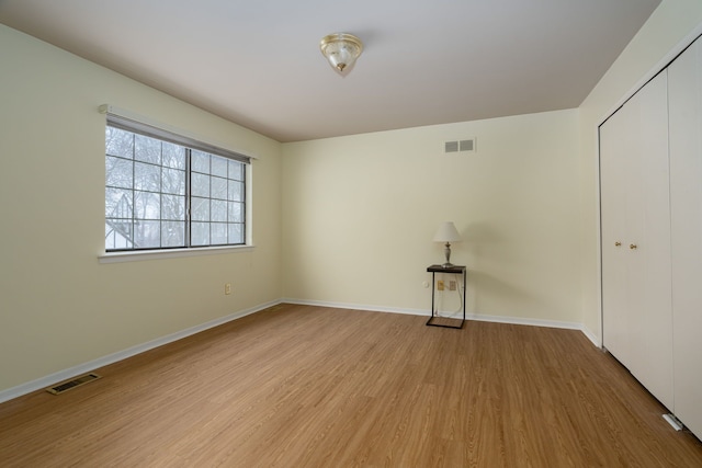 empty room with light hardwood / wood-style flooring