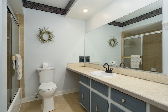 full bathroom featuring toilet, vanity, combined bath / shower with glass door, and tile patterned flooring