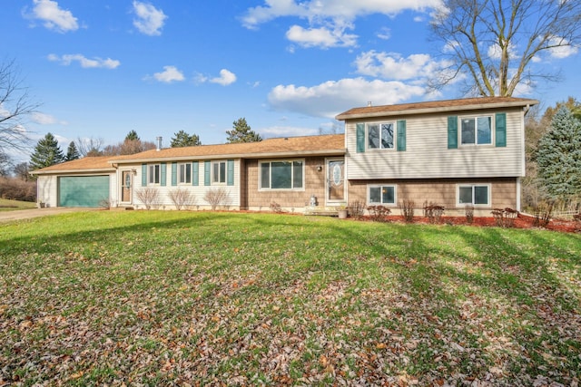 tri-level home with a garage and a front lawn