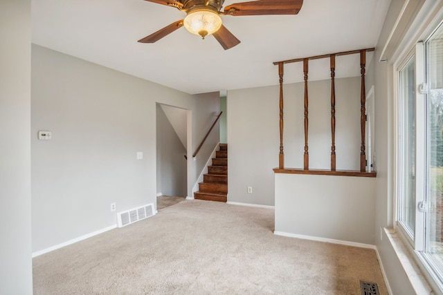 unfurnished room with light carpet and ceiling fan