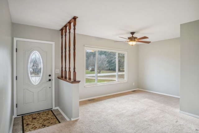 entryway with ceiling fan and carpet floors