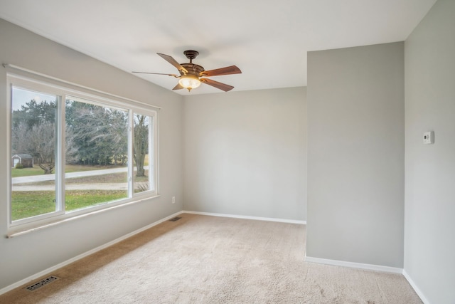 unfurnished room with ceiling fan and light colored carpet