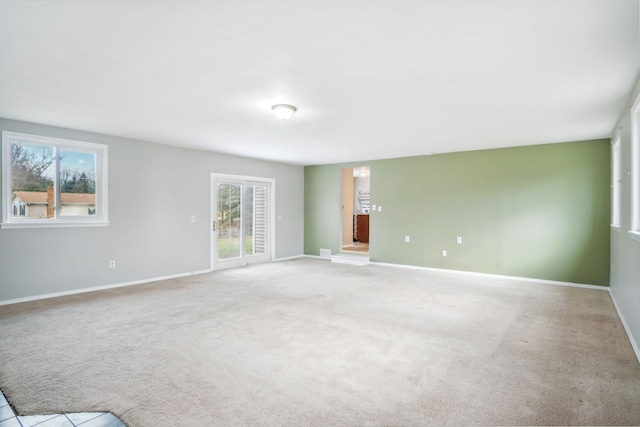 unfurnished room featuring light carpet