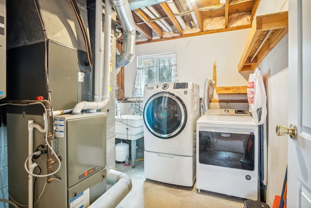 washroom with washing machine and dryer and heating unit