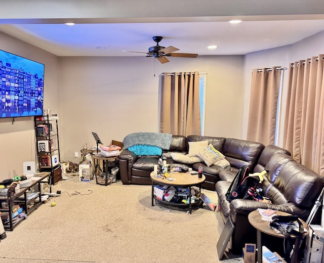 living room featuring ceiling fan and carpet