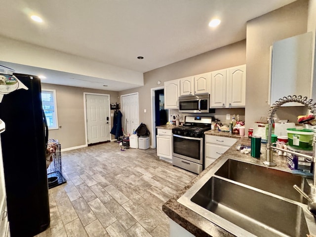 kitchen with white cabinetry, sink, and appliances with stainless steel finishes