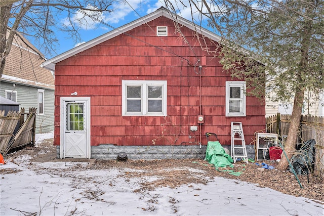 view of snow covered rear of property