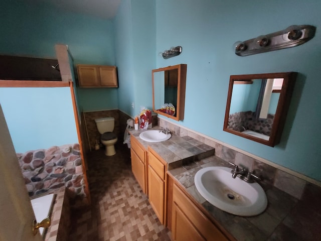 bathroom featuring vanity and toilet