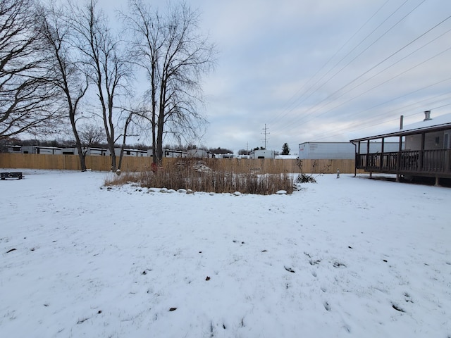 snowy yard with a deck