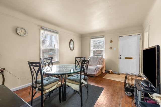 dining area with dark hardwood / wood-style flooring