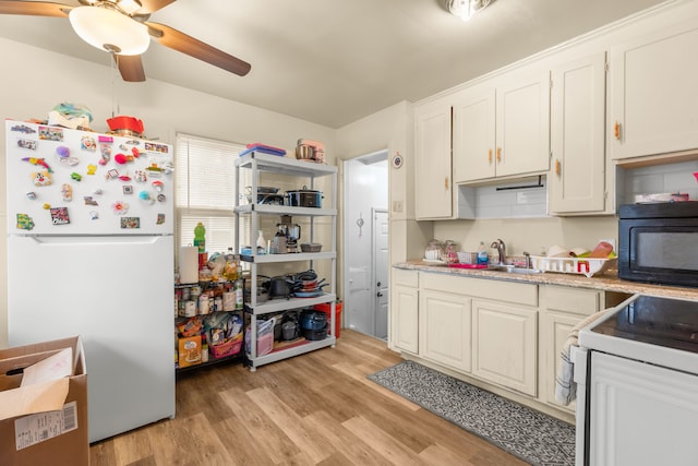 kitchen with white cabinetry, sink, ceiling fan, white appliances, and light hardwood / wood-style flooring