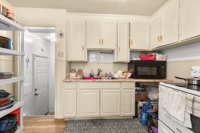 kitchen featuring light stone counters, sink, white cabinetry, and white range with electric cooktop