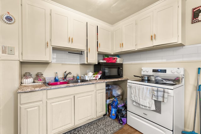 kitchen with wood-type flooring, sink, white range with electric stovetop, and white cabinets