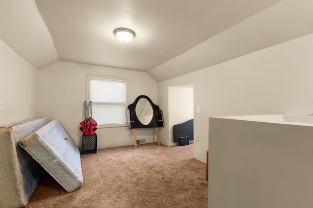 carpeted bedroom featuring lofted ceiling