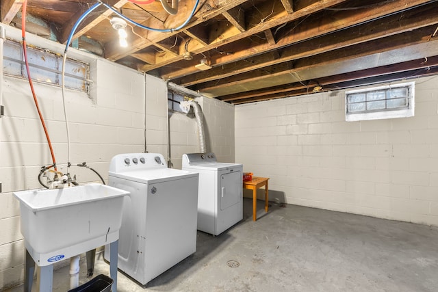 washroom with washing machine and dryer and sink