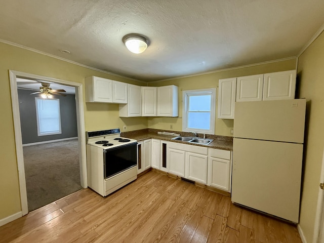 kitchen with white appliances, white cabinetry, a healthy amount of sunlight, and sink