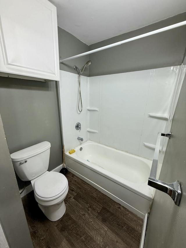 bathroom with shower / bath combination, toilet, and wood-type flooring