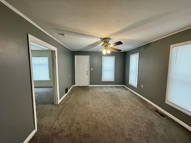 unfurnished room with ceiling fan, carpet floors, and ornamental molding