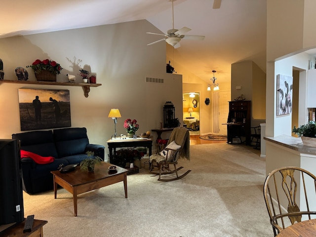 living room featuring high vaulted ceiling, light colored carpet, and ceiling fan with notable chandelier