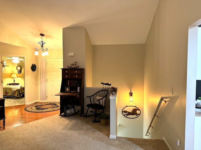 sitting room with vaulted ceiling, an inviting chandelier, and carpet floors