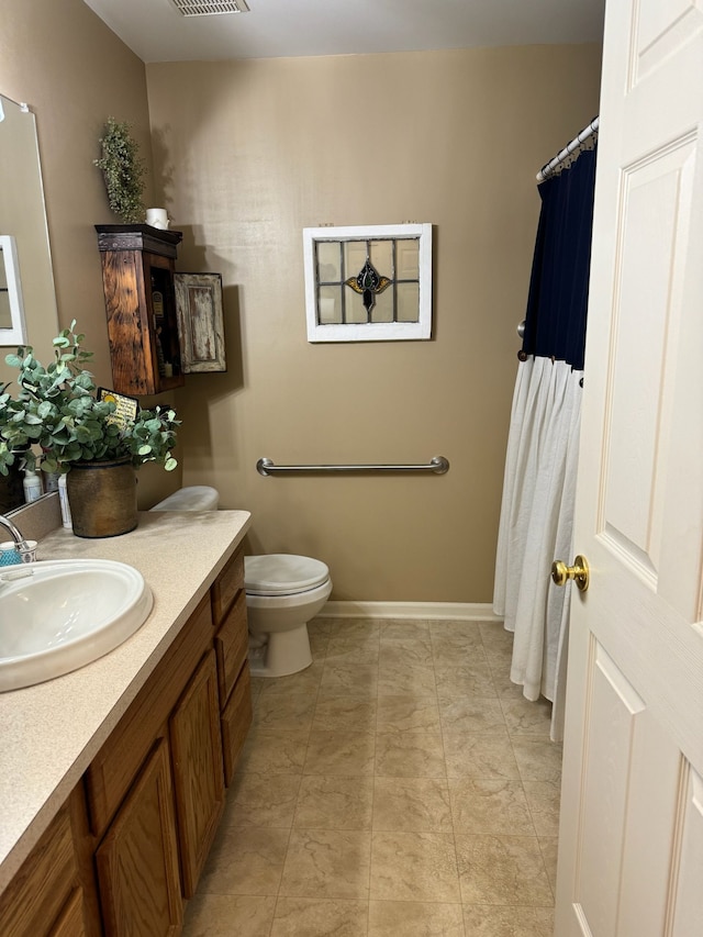 bathroom featuring toilet and vanity