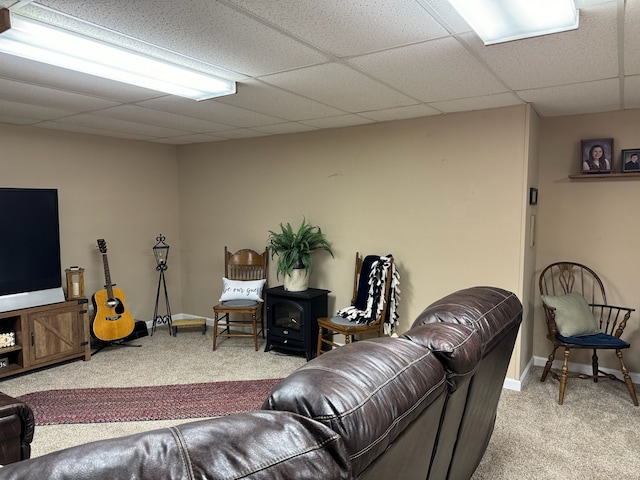 carpeted living room featuring a drop ceiling