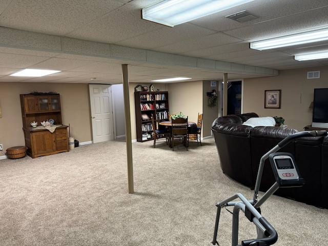 interior space with a paneled ceiling and carpet flooring