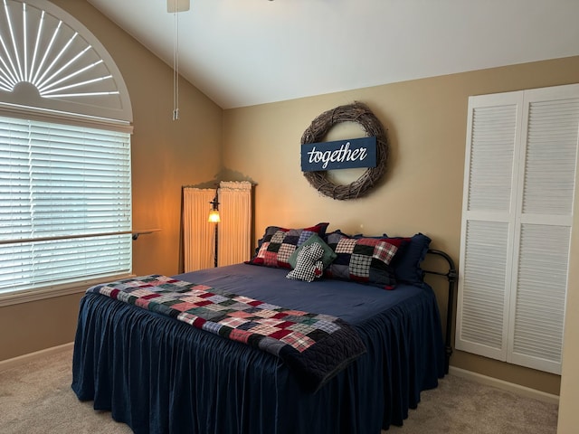 bedroom with vaulted ceiling and carpet flooring