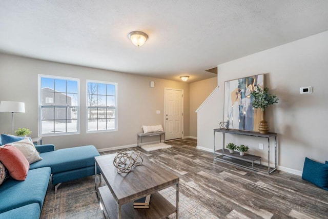 living room with a textured ceiling and dark wood-type flooring