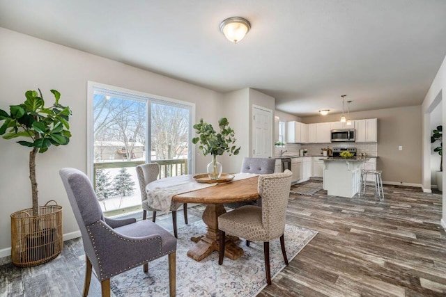 dining space with dark hardwood / wood-style floors