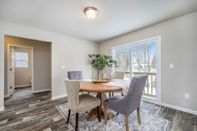 dining space with dark hardwood / wood-style flooring