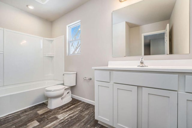 full bathroom with shower / tub combination, vanity, hardwood / wood-style flooring, and toilet