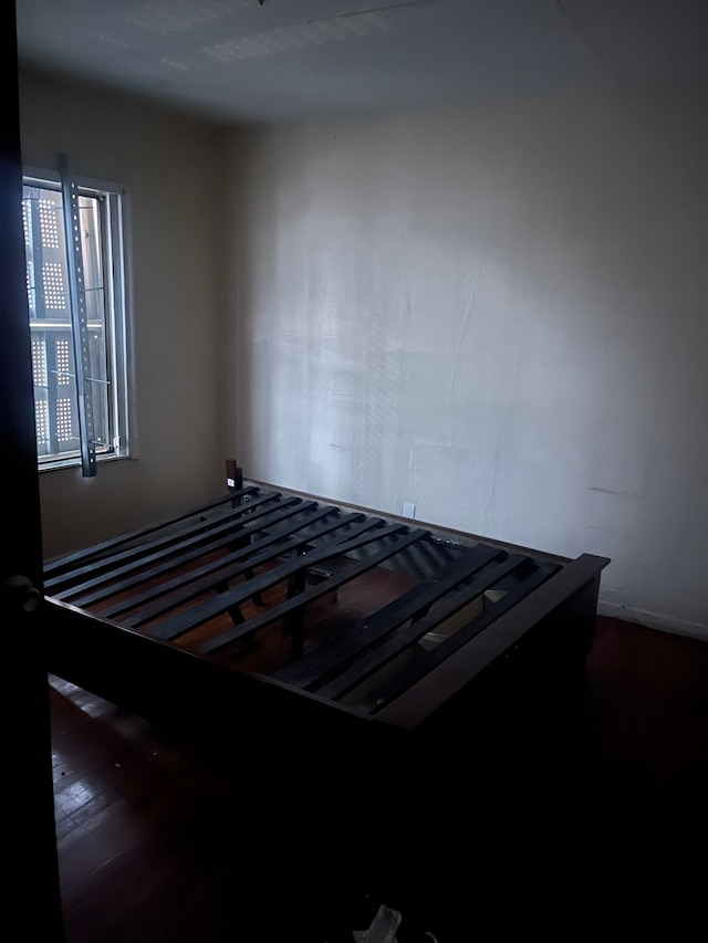 unfurnished bedroom with dark hardwood / wood-style floors