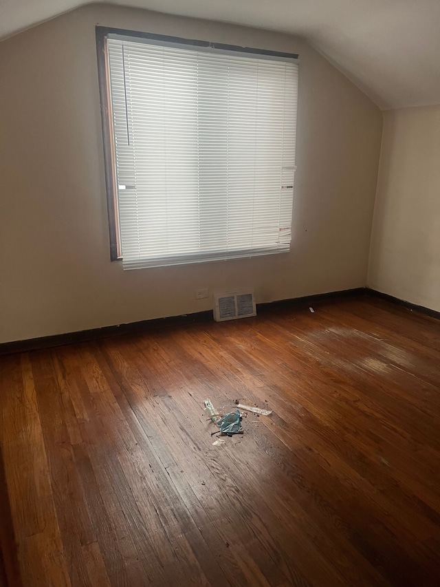 bonus room featuring dark hardwood / wood-style flooring and vaulted ceiling