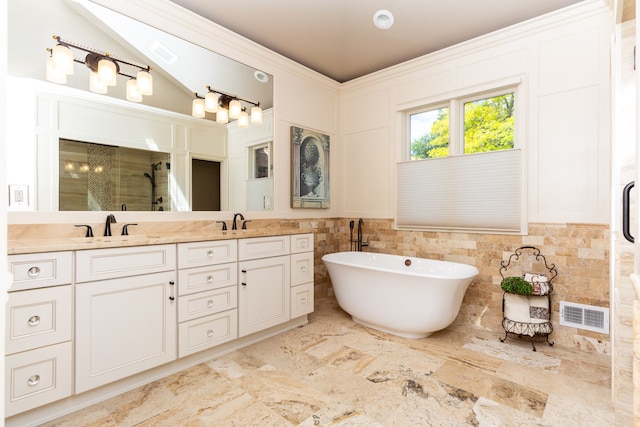 bathroom with vanity and independent shower and bath