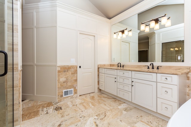 bathroom featuring vanity, walk in shower, and lofted ceiling