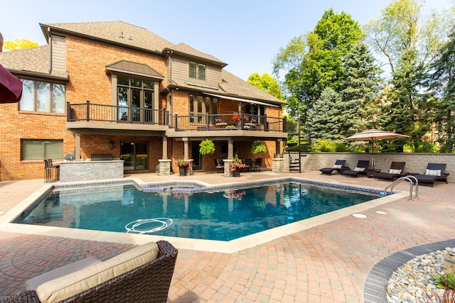 view of pool featuring a patio area and a bar