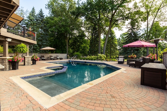 view of pool with a patio, outdoor lounge area, and an in ground hot tub