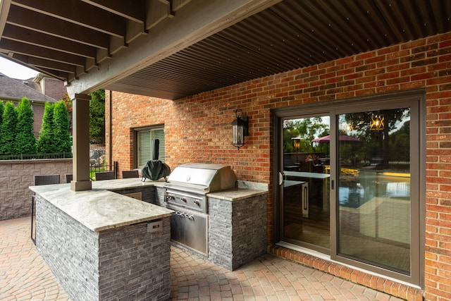 view of patio / terrace with exterior kitchen and a grill