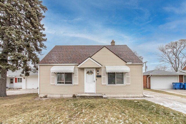 bungalow-style home with a front yard