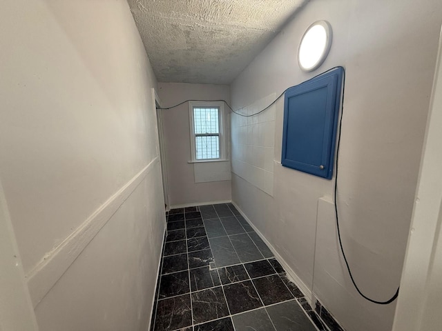 hallway with a textured ceiling