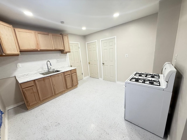 kitchen featuring decorative backsplash, white range with gas stovetop, and sink