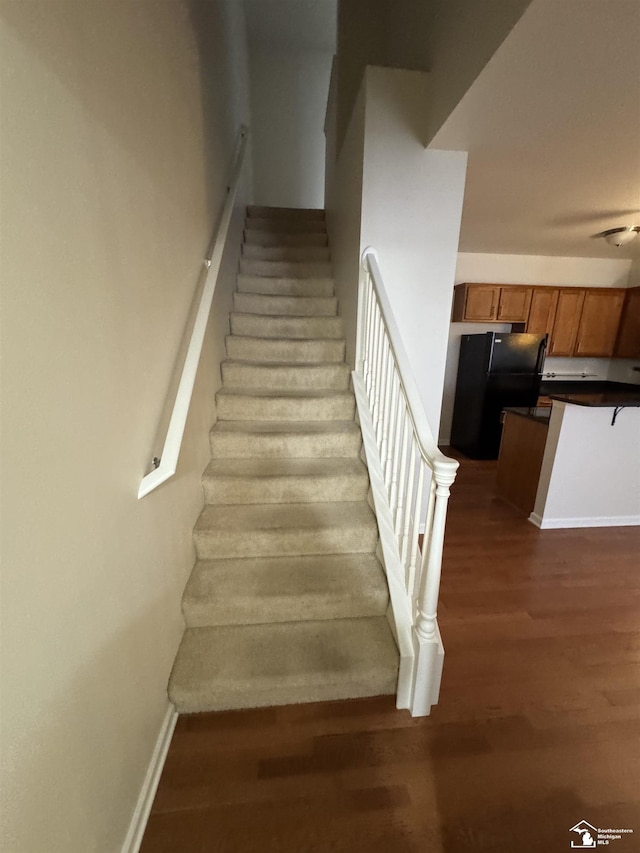 stairway featuring wood-type flooring