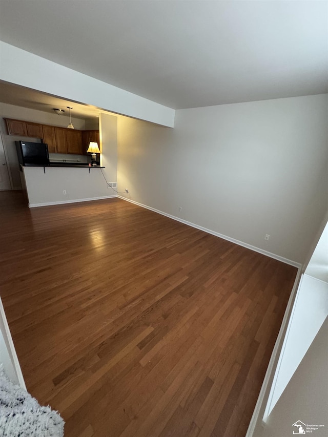 unfurnished living room featuring dark hardwood / wood-style floors