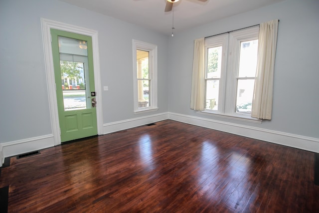 spare room with dark hardwood / wood-style flooring and ceiling fan