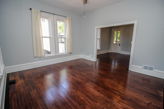 spare room featuring ceiling fan and dark wood-type flooring