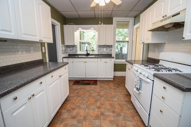 kitchen with white range with gas cooktop, white cabinetry, sink, and a paneled ceiling