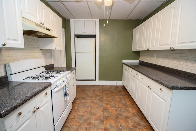 kitchen featuring white cabinets, a paneled ceiling, white appliances, and tasteful backsplash